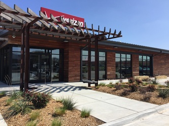 Retail building with hardwood accents and an exterior pergola