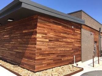 Warm brown tropical hardwood siding with varied natural grain
