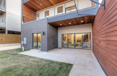 Contemporary residential entrance with wood soffits and siding